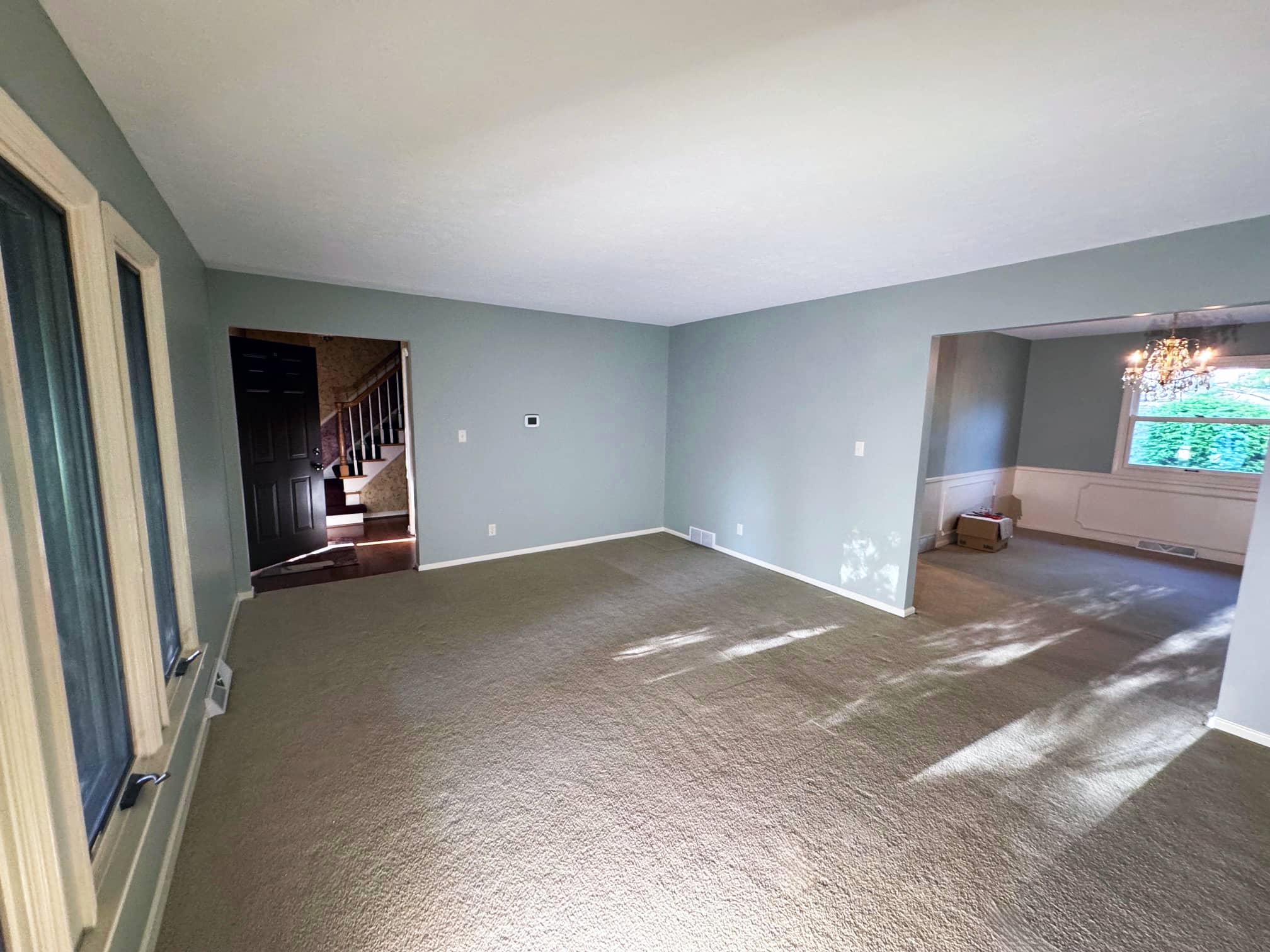 Spacious carpeted room with large windows and natural light in a Columbus suburb